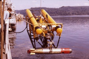CURV II, built to perform torpedo retrieval operations, is lifted to the surface holding a recovered Mark 46 torpedo .