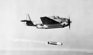 Aircraft flying above a torpedo it just launched