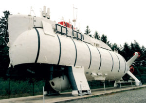 angled view of large white submersible with vertical black stripes
