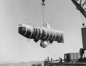 Trieste submersible suspended in air over water