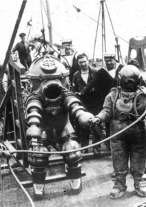 1930s mechanical diving suit on the deck of a ship