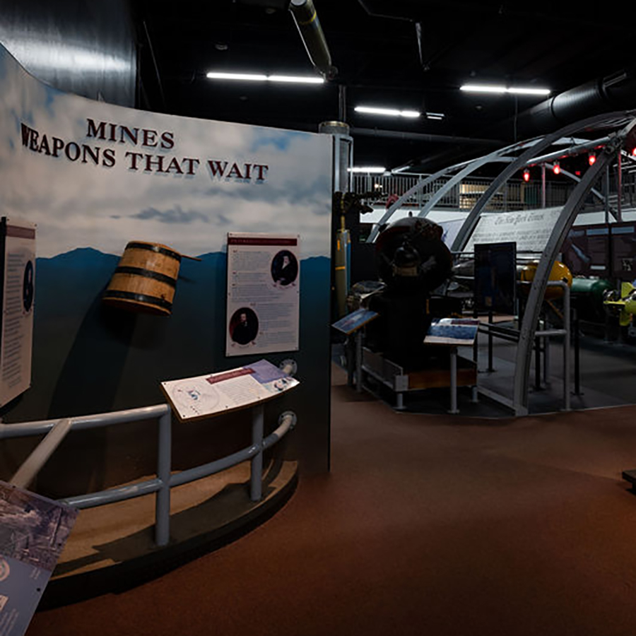 museum exhibit about mine warfare with exhibit title that reads "mines weapons that wait"