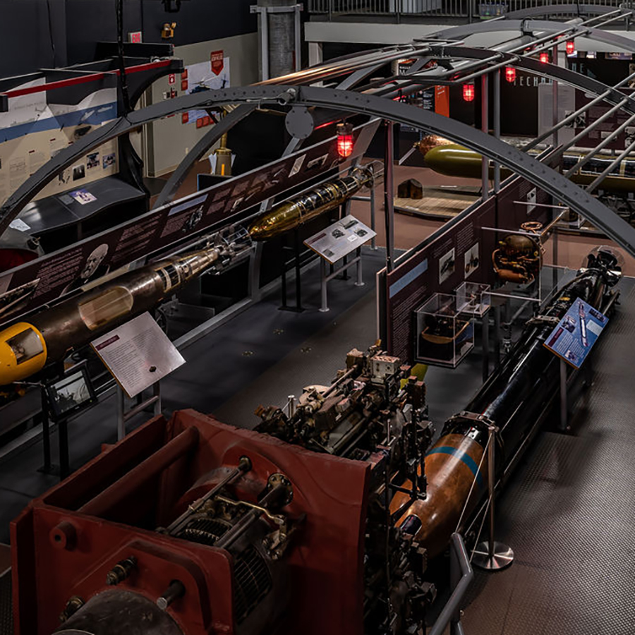 museum exhibit displaying historic and modern torpedoes