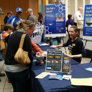 Museum staff interact with participants at outreach event